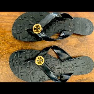 Tory Burch black patent flip flops . Size 8 1/2. Gold symbol.